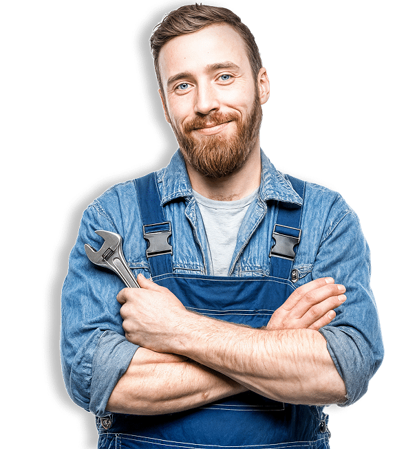 Mécanicien souriant en salopette denim bleue, bras croisés, tenant une clé à molette. Homme barbu aux yeux bleus, confiant.